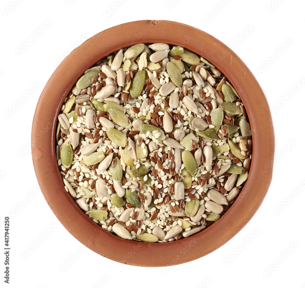 Mix seeds, sunflower, sesame, linseed and pumpkin seed in clay pot isolated on white background, top view Mix seeds, sunflower, sesame, linseed and pumpkin seed in clay pot isolated on white background, top view