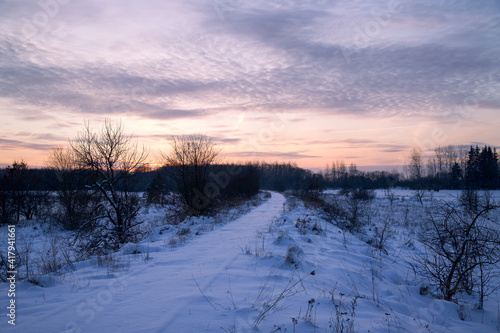 Winter landscape with a colorful sky at sunset time.