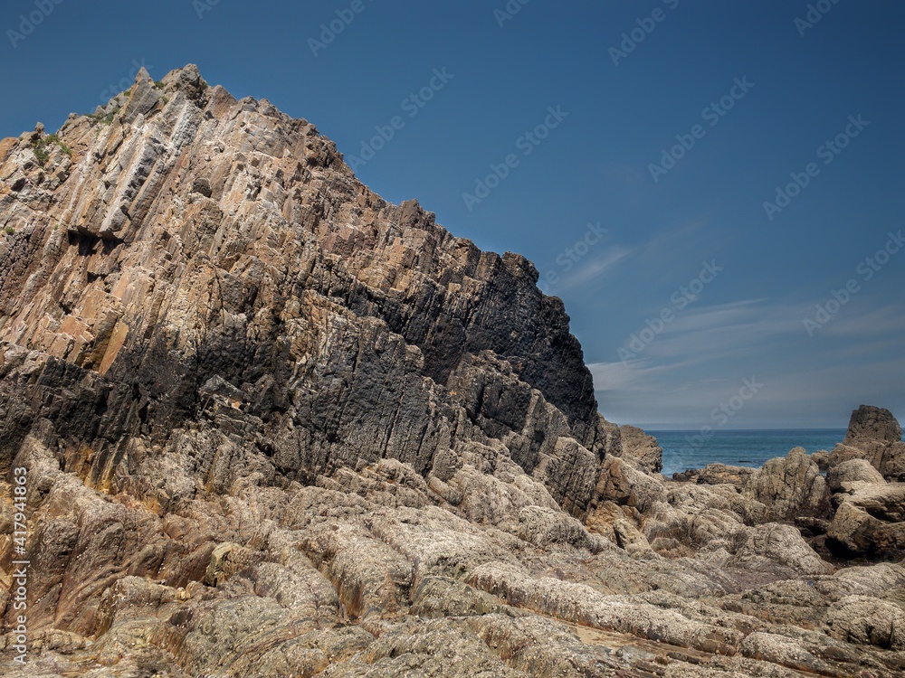 Rocks with straight edges on a beach
