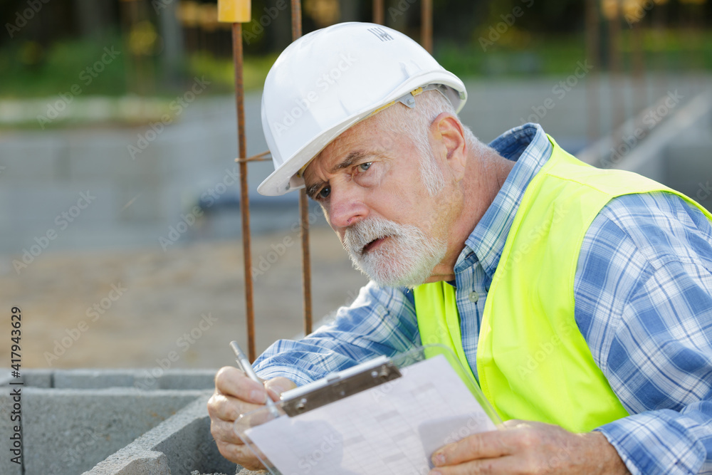 bearded engineer at the construction with clipboard bearded engineer at the construction with clipboard