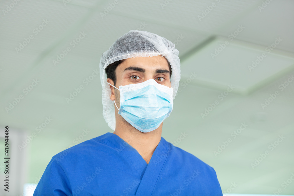 doctor in blue uniform standing in hospital