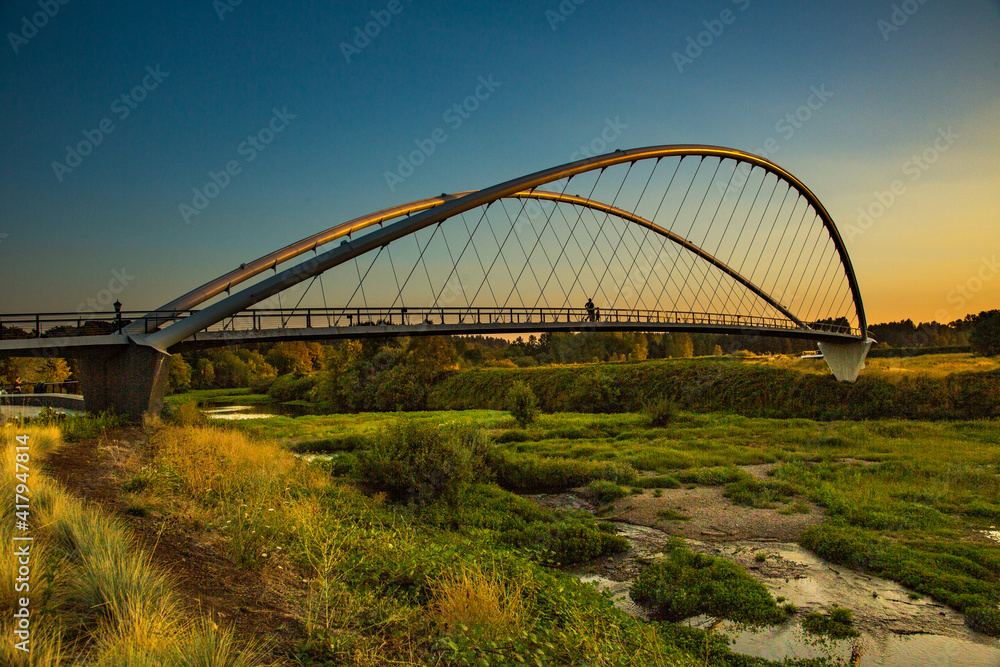 Double arch footbridge at sunset from Salem Riverfront park to Minto Island, Oregon. Double arch footbridge at sunset from Salem Riverfront park to Minto Island, Oregon.