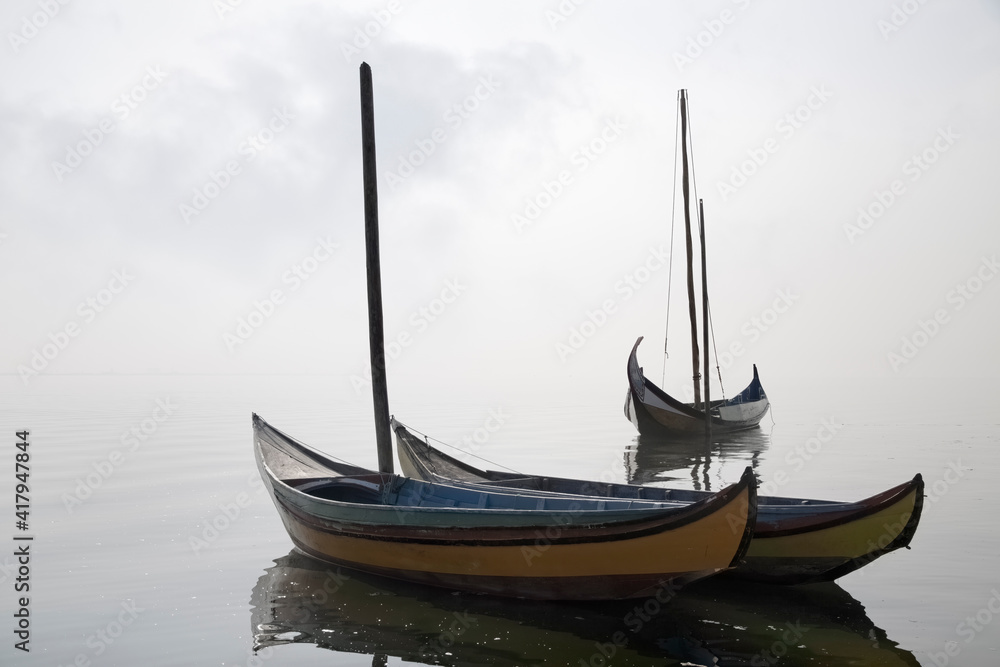 Traditional fisherman wooden boats in the fog