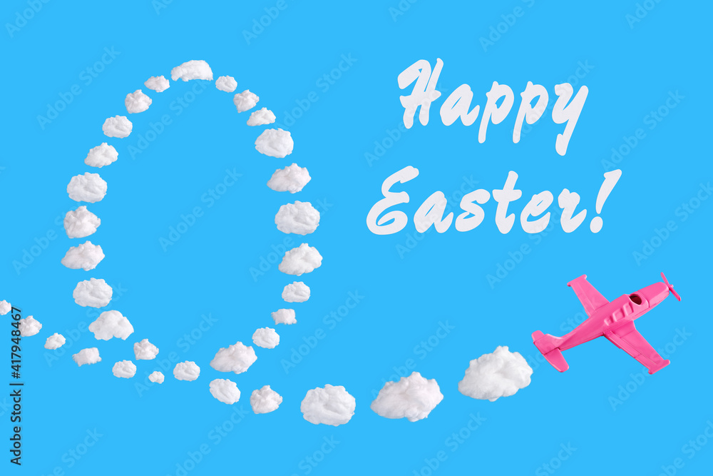 Pink airplane goes into a turn on blue background with text happy easter and easter egg of abstract shapes of cloud. Festive minimal composition, holiday concept