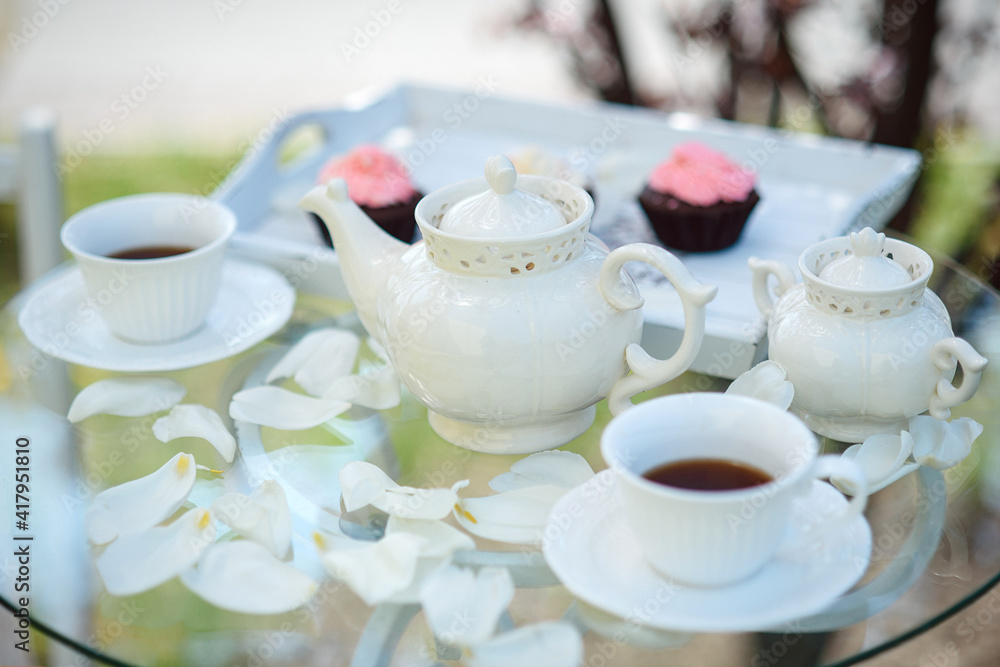 Fototapeta premium Tea drinking black tea with porcelain cups and a teapot