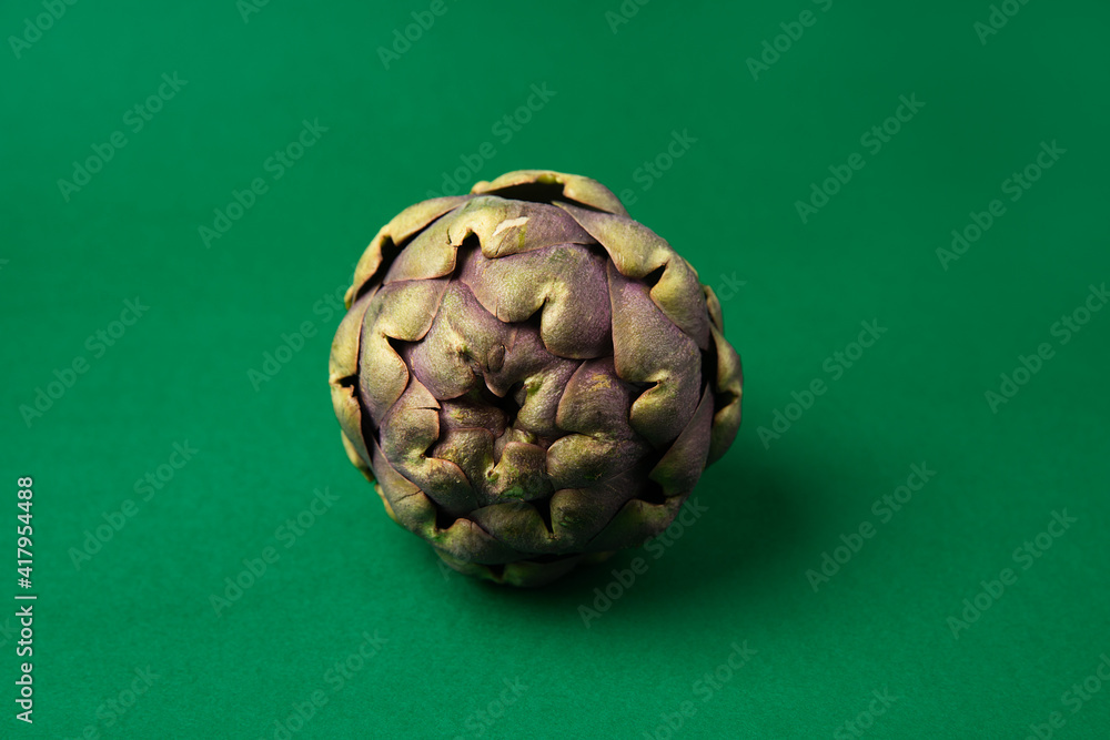 Fototapeta premium Fresh Artichoke on the dark green background