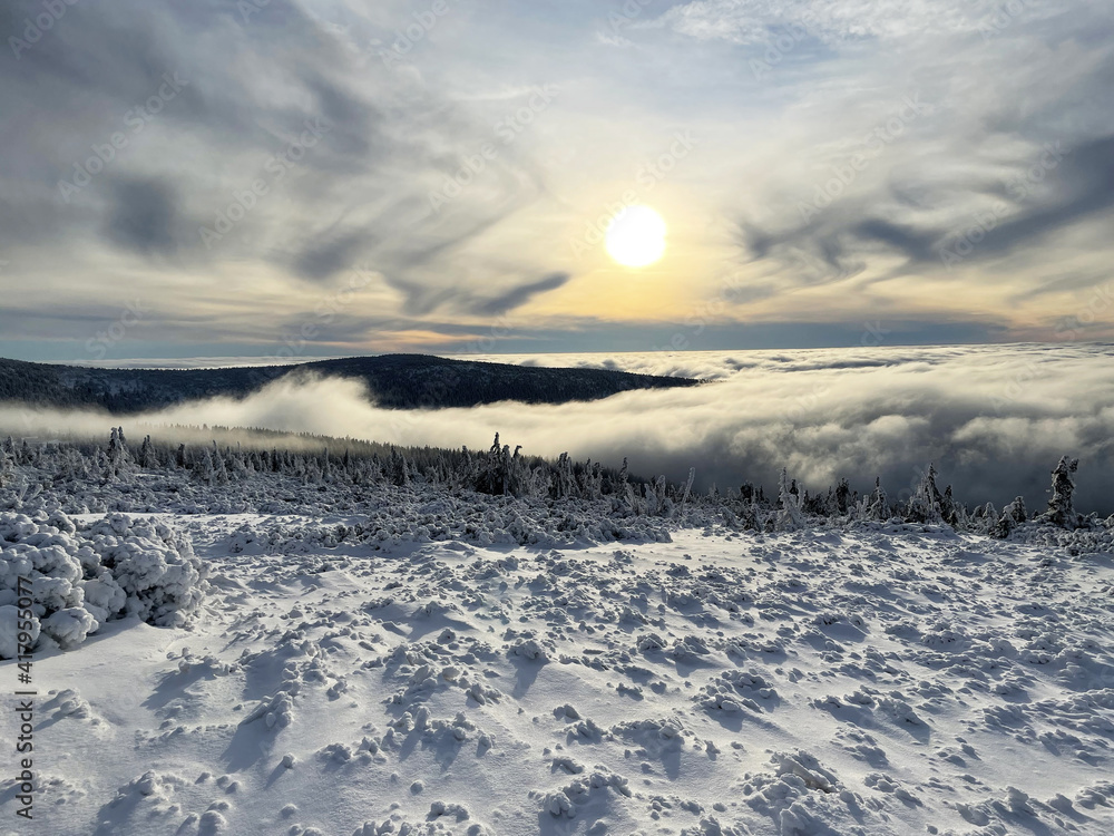 winter view of snowy mountain ridges in the clouds, Giant Mountains, Czech Republic