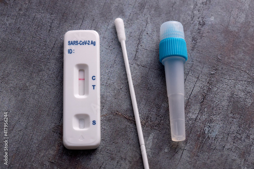 Covid-19 lateral flow test kit on grey surface photo