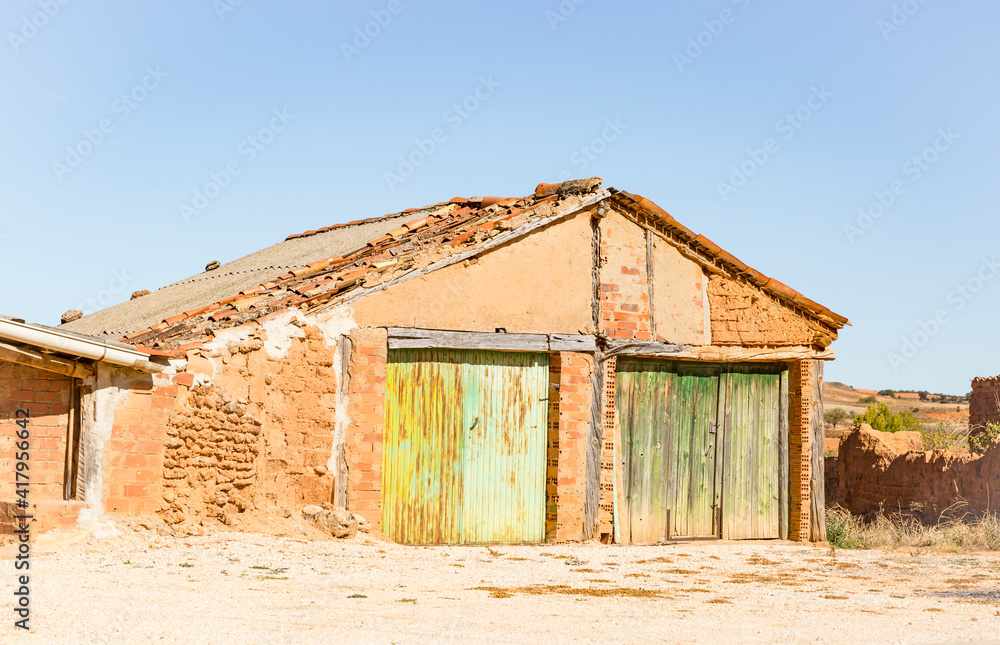 a rural warehouse made of clay and bricks with two gates a rural warehouse made of clay and bricks with two gates