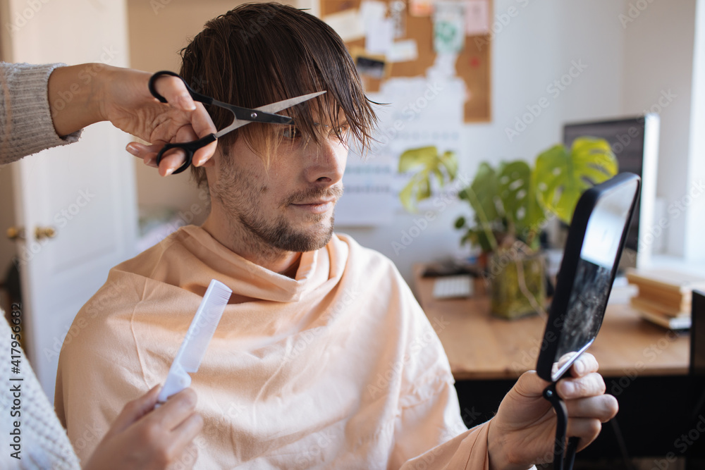 Wife cuts husband's hair quarantine Home haircut. Life in pandemic