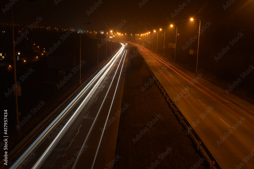 Night blurred traffic, light lines, highway 