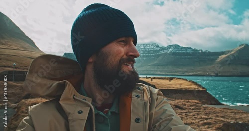 Selfie video of a man in front of a lake in a cold sunny day. 