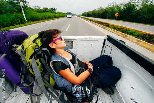 girl traveller sleeps in a pickup truck, colombia - june, 2019 photo