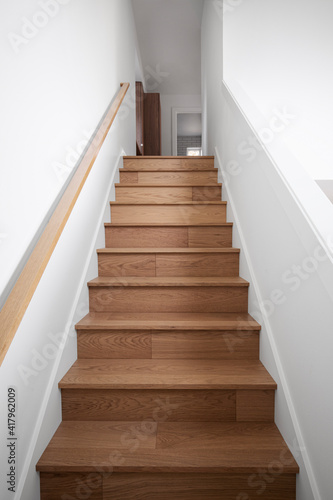 Wooden staircase in the house leading to the second floor © Studio D
