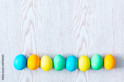 colorful easter eggs on wooden background with copy space, spring, easter concept