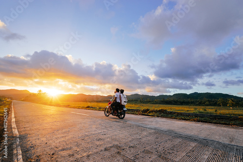 Motobike on the road at sunset time.