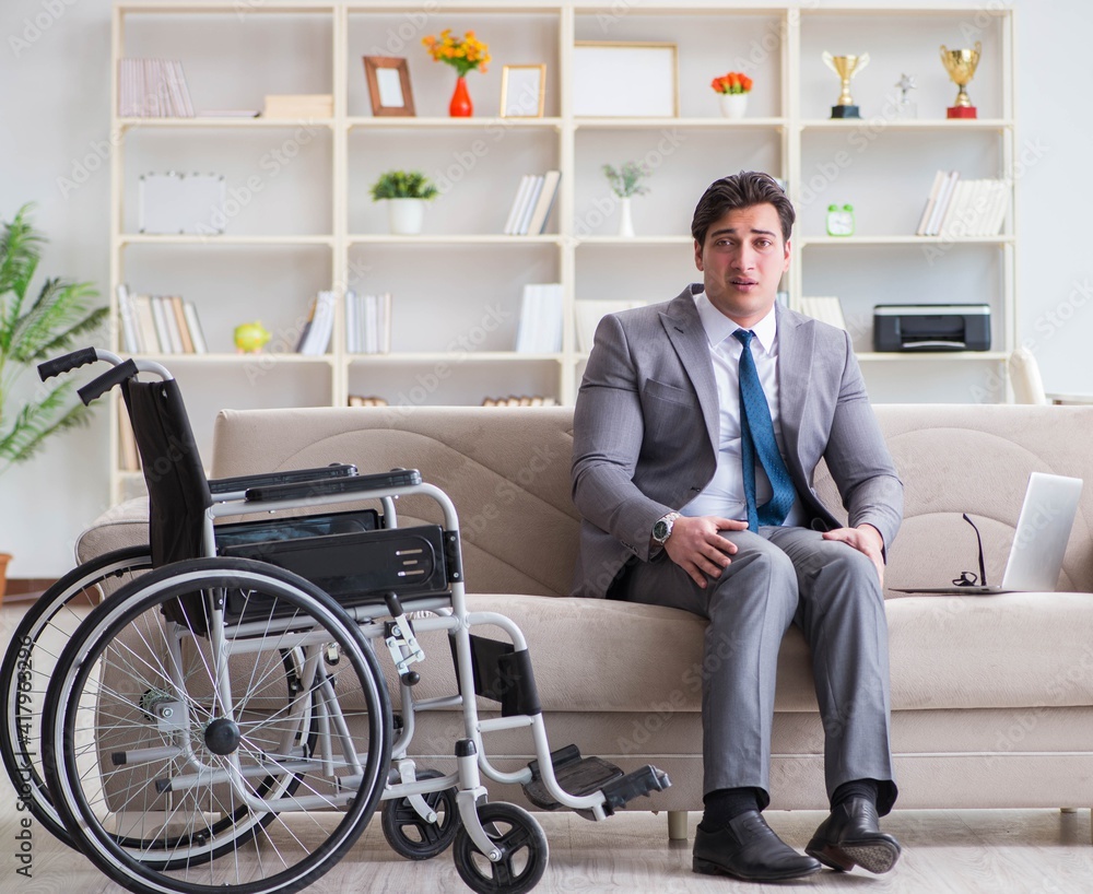 Dsabled businessman on wheelchair working home Dsabled businessman on wheelchair working home