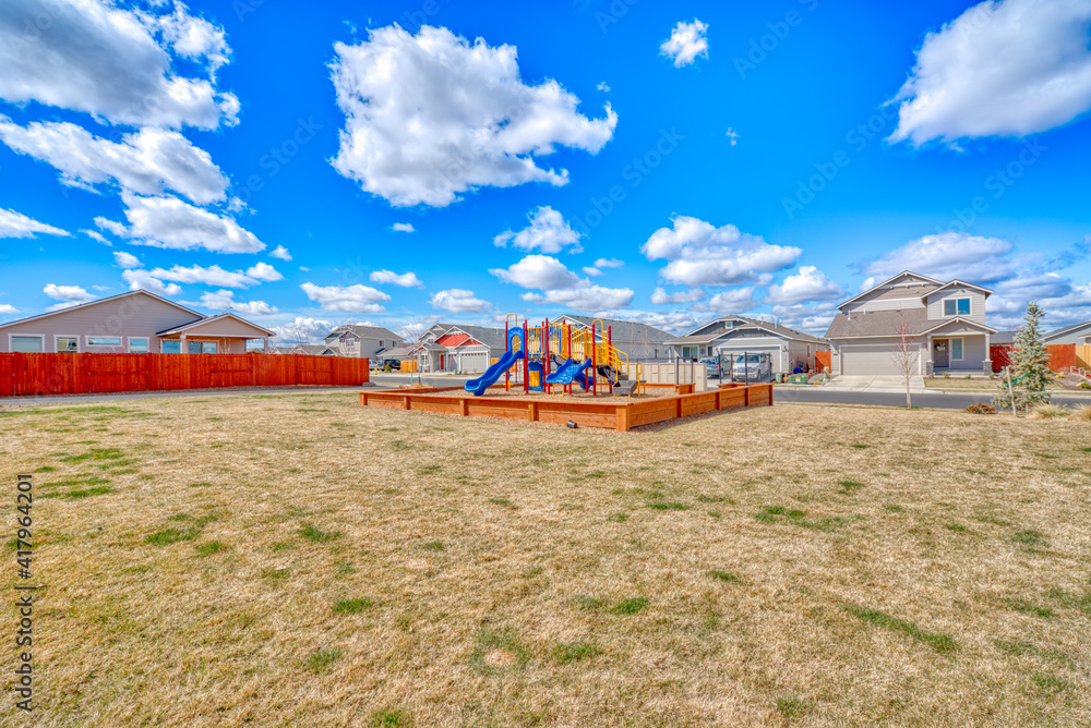wide shot of colorful playground equipment in a neighborhood