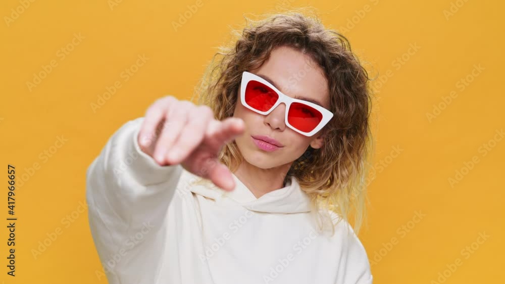 Dancing Happy Young Woman Raises her Hands Up Moves Rhythmically to Music Sings Slow Motion on Yellow Background Close-up. Portrait Glamorous, Girl Dancing in sunglasses. Positive Emotions. Freedom Dancing Happy Young Woman Raises her Hands Up Moves Rhythmically to Music Sings Slow Motion on Yellow Background Close-up. Portrait Glamorous, Girl Dancing in sunglasses. Positive Emotions. Freedom