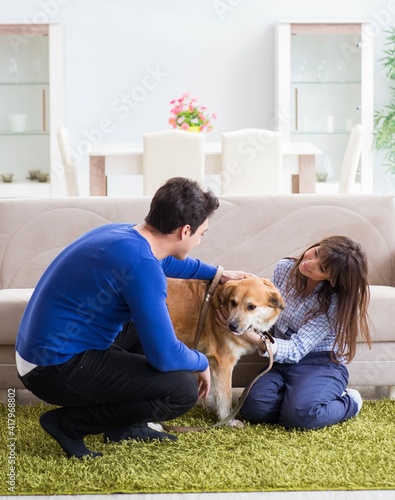 Happy family with golden retriever dog