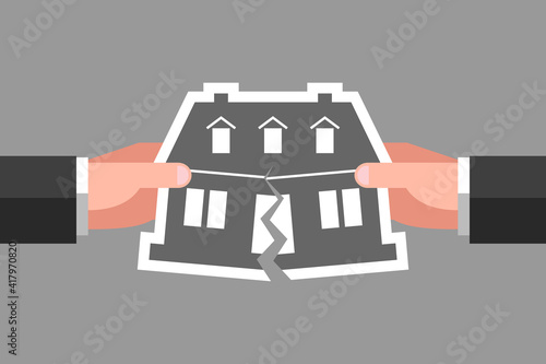 Two hands are tearing icon of house, concept of real estate division