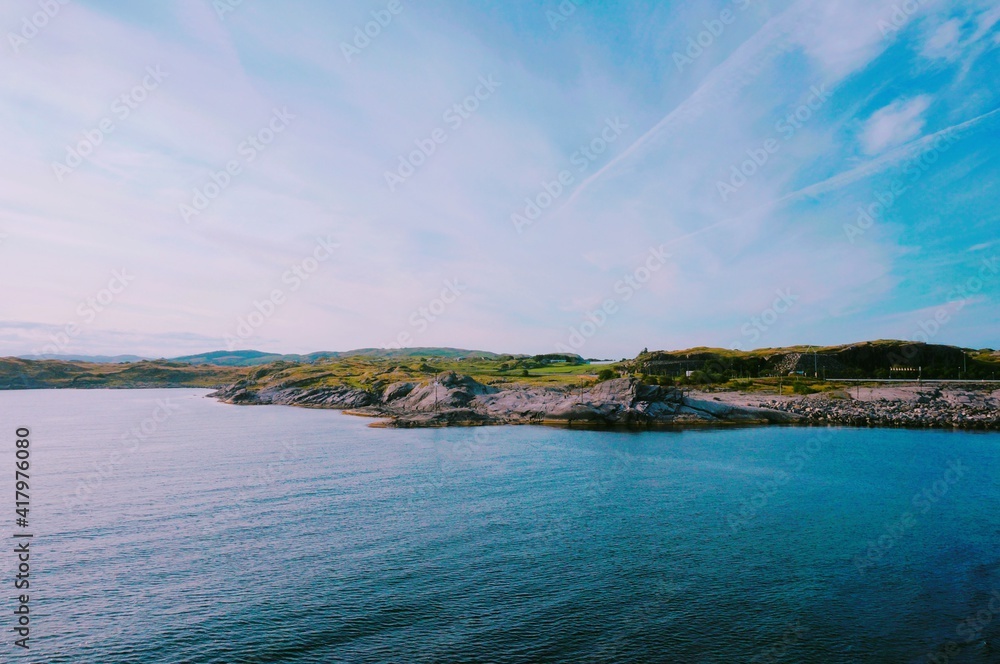 Obraz premium Rocky Coastline and Blue Sea under a Clear Sky