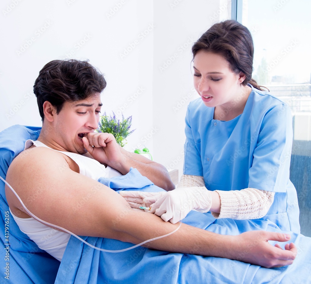 Doctor doing medical injection in hospital room Doctor doing medical injection in hospital room