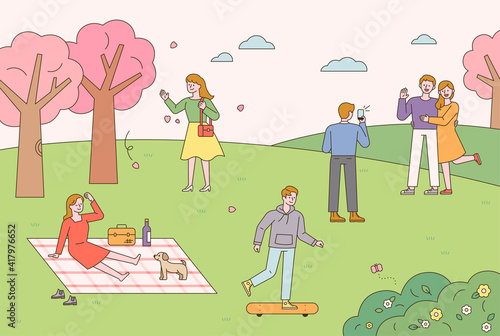 People are doing outdoor activities in a park where spring flowers bloom. People having picnics, riding boards, and taking pictures. flat design style minimal vector illustration.