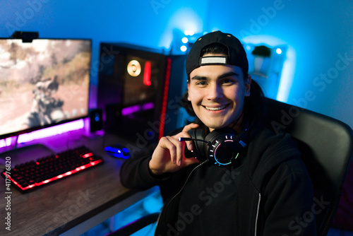 Handsome hispanic man feeling happy while playing a videogame