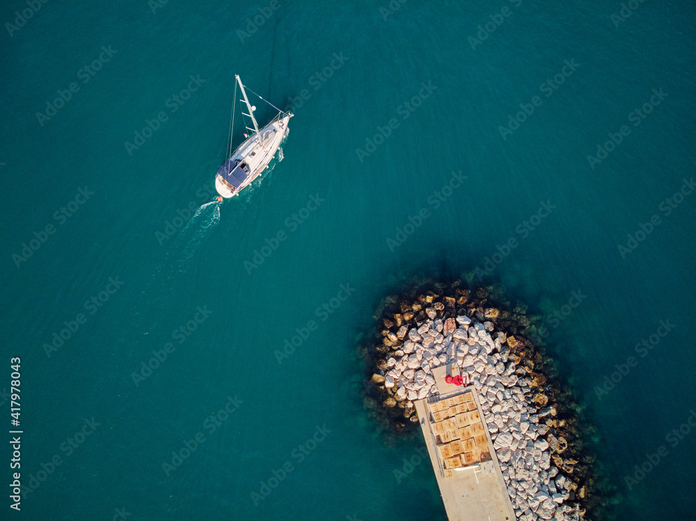 Obraz premium Aerial top view from drone of lagoon marine with yacht.