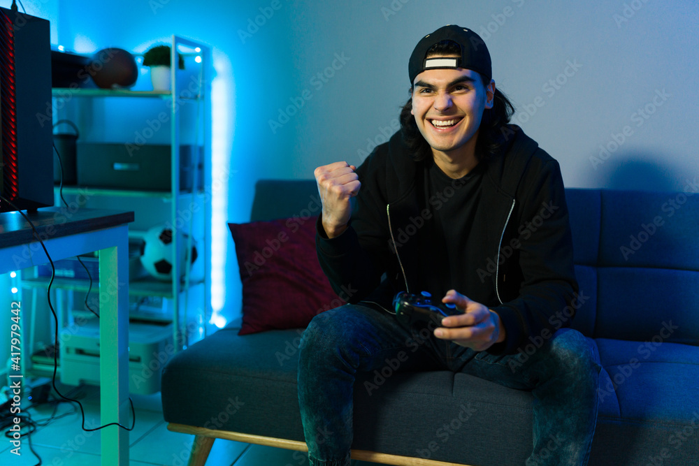 Winner gamer celebrating after finishing a videogame