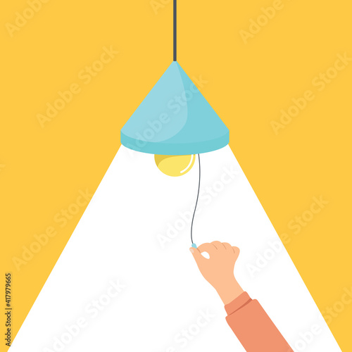 Hand turn on the lamp for the light at night, hand holding a lamp