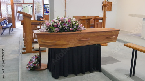 closeup shot of a funeral casket in a hearse or chapel or burial at cemetery 