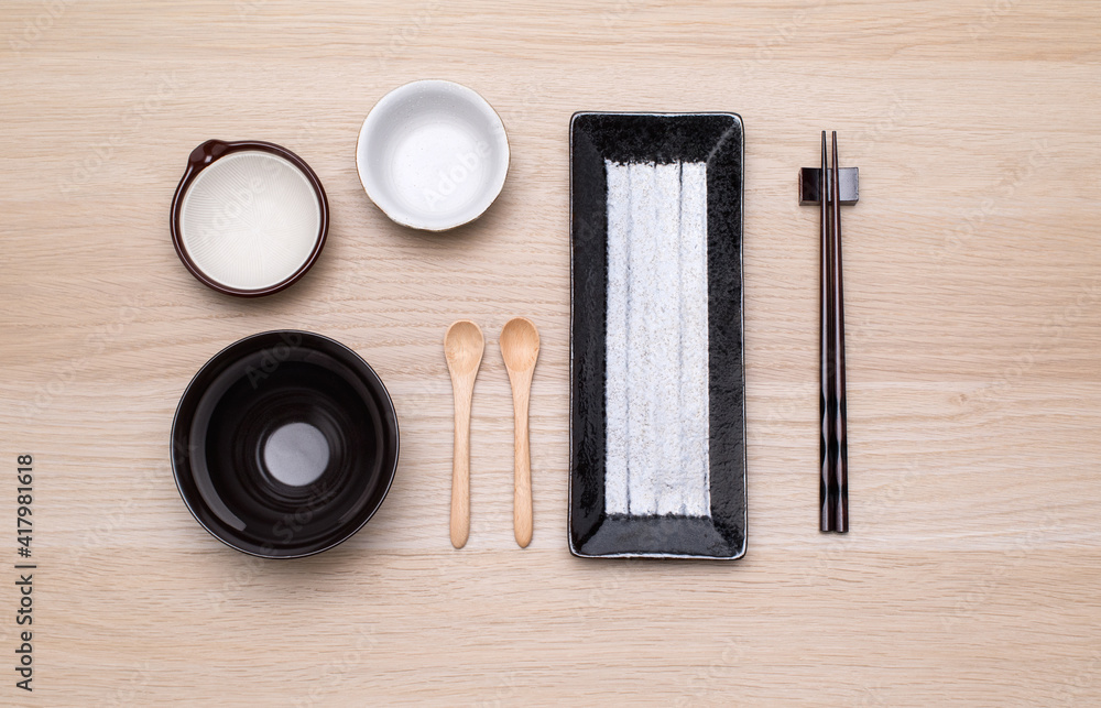 Oriental plates and chopsticks on wooden background.. Oriental plates and chopsticks on wooden background..