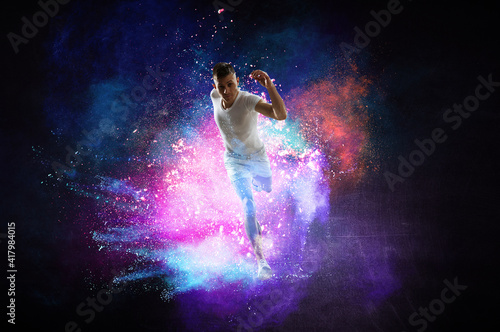 Portrait of a fitness man running on a colourful background