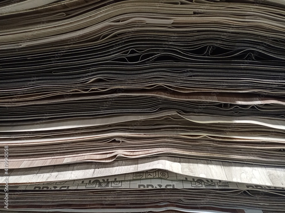 A bunch of leftover pieces of linoleum stacked on top of each other. A bunch of leftover pieces of linoleum stacked on top of each other.