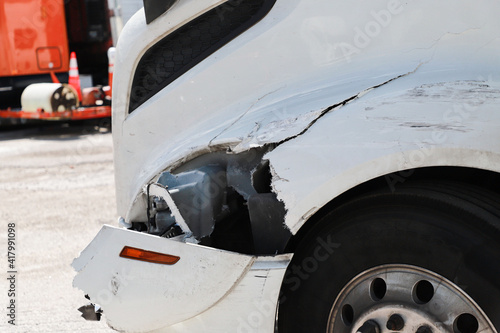 Damage closeup on white truck.