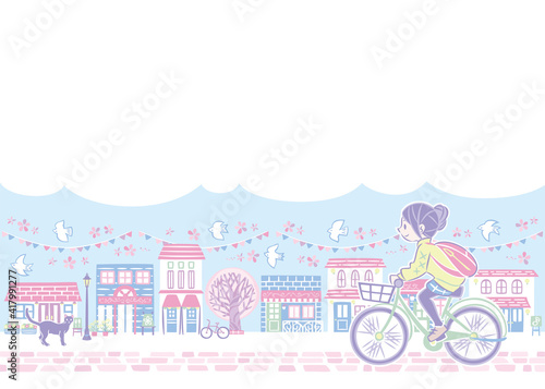 春の桜の街並みで自転車に乗る女性