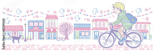 春の桜の街並みで自転車に乗る男性