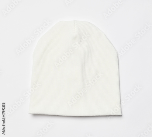 Modern knitted white beanie hat, knitwear isolated on white background