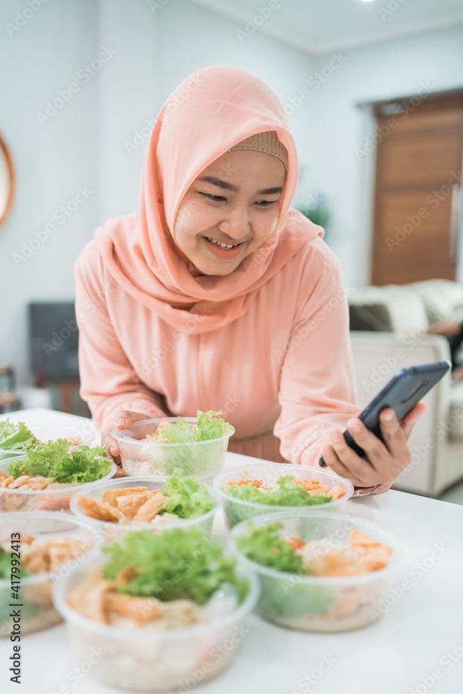 muslim asian woman home catering service preparing lunch box for takeaway food online order muslim asian woman home catering service preparing lunch box for takeaway food online order