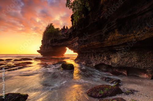 Dramatic Sunset color at Batu Bolong temple and Tanah Lot  Tabanan  Bali. beautiful view with the coral reef in low tide.
