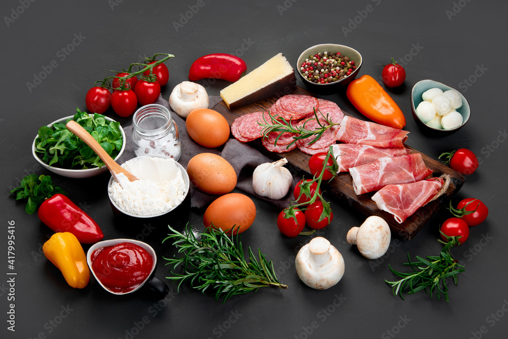 Italian pizza preparation. Variety of traditional cooking ingredients.