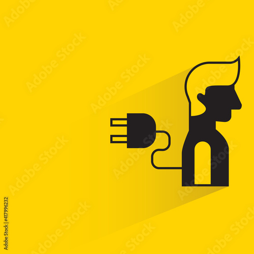 human and plug with shadow on yellow background