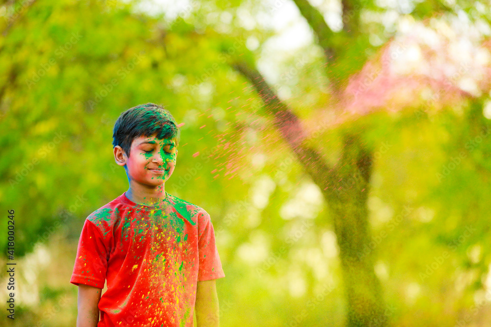 Holi celebrations -Indian little boy playing Holi and showing face expression. Holi celebrations -Indian little boy playing Holi and showing face expression.