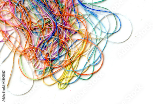 Multicolor tangled color needlecraft silk cord. Abstract color background, in white background	 photo