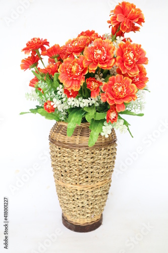 Fototapeta Naklejka Na Ścianę i Meble -  Plastic Flower is in wicker basket or rattan basketry or rattan pot isolated on white background. decoration for interior