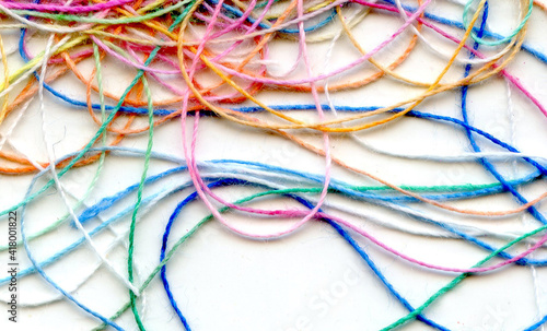 Multicolor tangled color needlecraft silk cord. Abstract color background, in white background	 photo