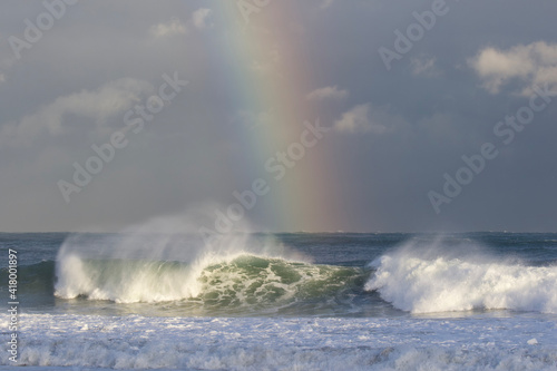A stunning Vivid Rainbow formed over the Pacific Ocean close to where a large surfing competition is held in Chiba  Japan. There are large waves breaking onto the beach. It s close to Tokyo