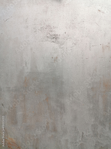 texture of old painted rusty grey wall or garage door with peeling and cracked paint and corrosion